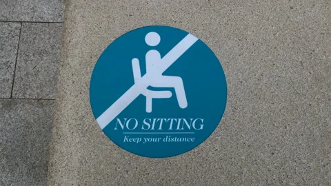 A No sitting sign sticker, Broadgate Circle shopping centre. London. Stock Footage 145880406