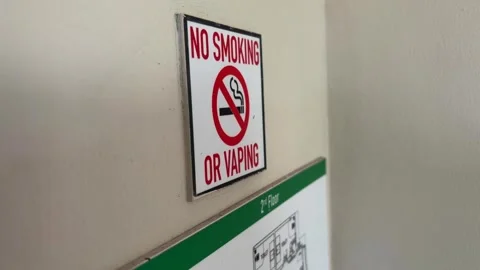 No smoking and no vaping sign on wall showing prohibition symbol in public Stock Footage 333825342