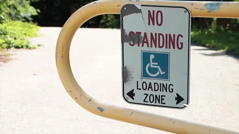 No standing loading zone with handicap symbol and two arrows pointing opposite Stock Footage 249420992