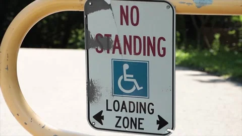 No standing loading zone with handicap symbol and two arrows pointing opposite Stock Footage 249421035