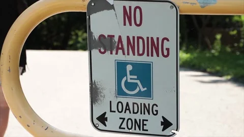 No standing loading zone with handicap symbol and two arrows pointing opposite Stock Footage 249421091