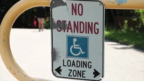 No standing loading zone with handicap symbol and two arrows pointing opposite Stock Footage 249421126
