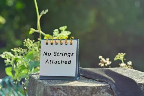 No strings attached text written on white note with green blurred background Stock Photos