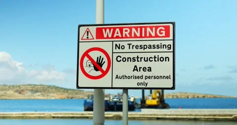 No Trespassing rectangular plaque with Construction Area Warning near sea Stockbeeldmateriaal 310311369