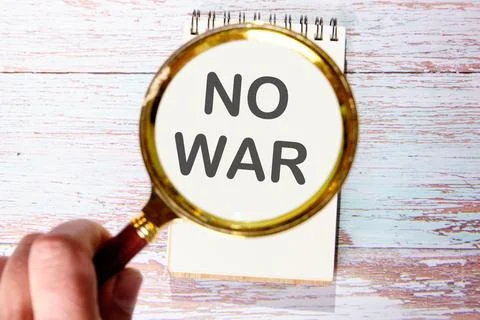 NO WAR text seen through magnifying glasses on a notepad Stock Photos