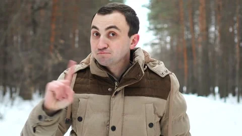 No, Young Man Rejecting Offer by Waving Finger Against Backdrop of Winter Forest Stock Footage 106877105