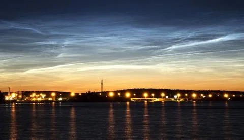Noctilucent clouds glowing over a river Stock Photos