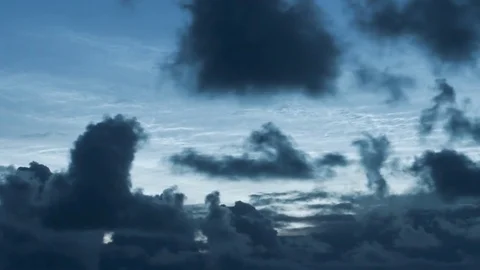 Noctilucent clouds NLC with filament gravity wave structure behind low Stock Footage 77913766