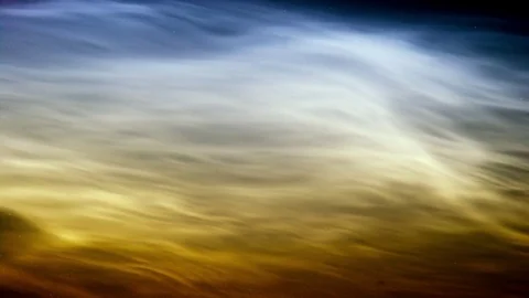 Noctilucent clouds NLC with filament gravity wave structure in midnight sun Stock Footage 77916273