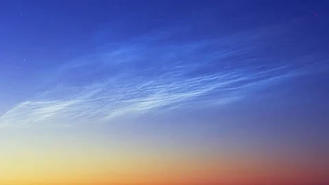 Noctilucent clouds NLC with filament gravity wave structure in summer morning Stock Footage 77916300