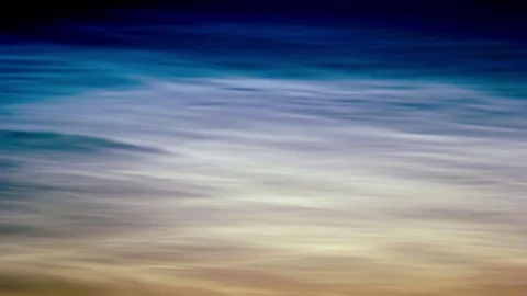 Noctilucent clouds NLC with filament gravity wave structure in midnight sun Stock Footage 77916304