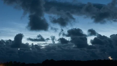 Noctilucent clouds NLC with filament gravity wave structure behind low Stock Footage 77916334