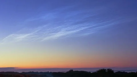 Noctilucent clouds NLC with filament gravity wave structure in summer morning Stock Footage 77916382