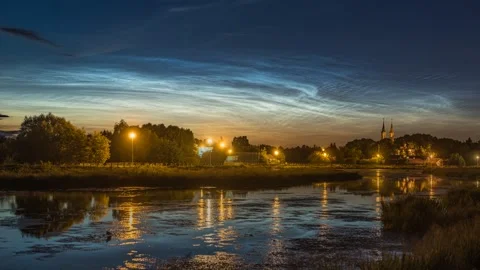 Noctilucent clouds in a time-lapse technique seen over the riverbank Stock Footage 301406668