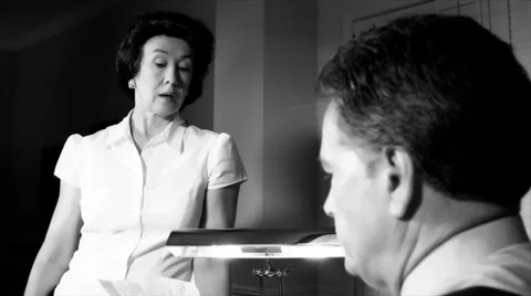 Noir upset wife talking to husband Stock Footage
