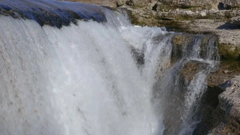 Noisy flow of water falls under rocks 스톡 동영상 74075264