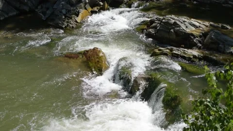 Noisy mountain river flows among large stones 스톡 동영상 149450683