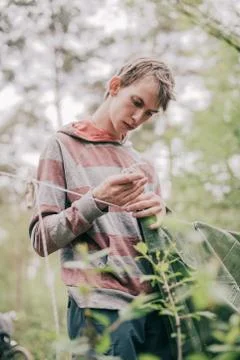 Nomad setting up campsite in spring forest. Stock Photos