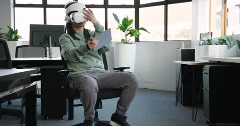 Non-binary African American holding gray tablet, testing virtual object using VR Stock Footage 342068513