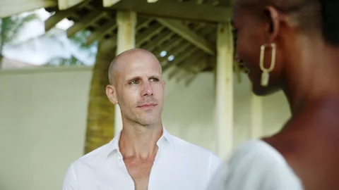 Non-binary black person and his fiance looking lovingly at each other at ocean Stock Footage 252689552