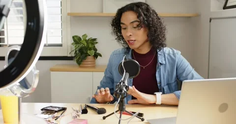 Non-binary creator prepping laptop, ring light and mic, showcasing brushes Stock-Footage 342111818