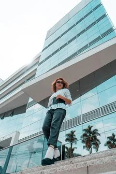 Non-binary executive young of LGBTQ community walking on stairs front of a Stock Photos