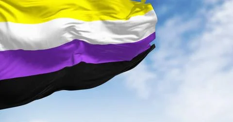 Non-binary flag waving on a clear day Non-binary flag waving on a clear da... Stock Photos