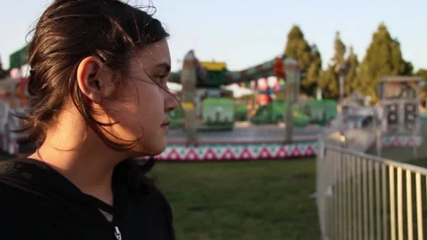 Non binary kid at deserted carnival Stock Footage 154940729