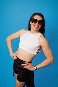 Non-binary or trans men with glasses on blue background Stock Photos