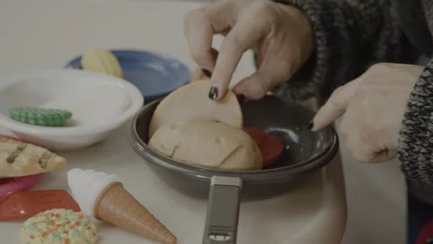 Non binary parent playing with child close up on hands Stock Footage 166163453