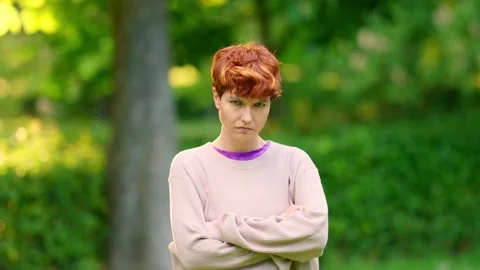 Non-binary person crossing arms in anger outdoors Видео 196144816