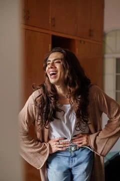 Non-binary person getting dressed in front of the mirror Stock Photos