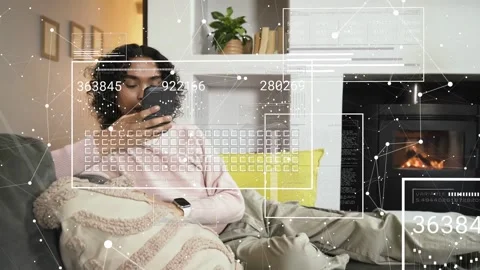 Non-binary person reclining on couch, tapping smartphone and causing animated AR Stock Footage 333510364