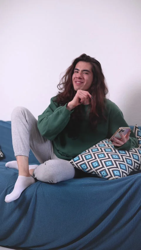Non-binary person, on the sofa very happy Stock Footage 309138041