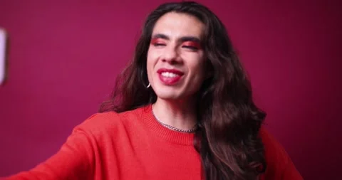 Non-binary person talking on cell phone with a happy expression on their face Stock Footage 309137586
