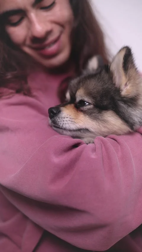 Non-binary person, with their pet on the sofa very happy with lots of love Stock Footage 309137810