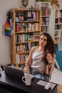 Non-binary person thinking about what to do from their home office Stock Photos