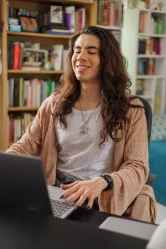 Non-binary person wearing glasses working from home Stock Photos
