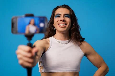 Non-binary stylish person creating content with their cell phone like an in.. Stock Photos