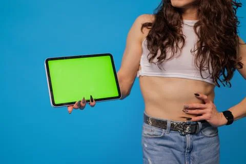 Non-binary stylish person smiling with tablet and green screen for animation Stock Photos