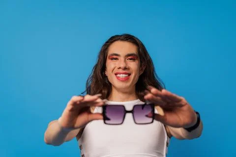 Non-binary stylish person, trans men wearing glasses posing with happy face.. Stock Photos