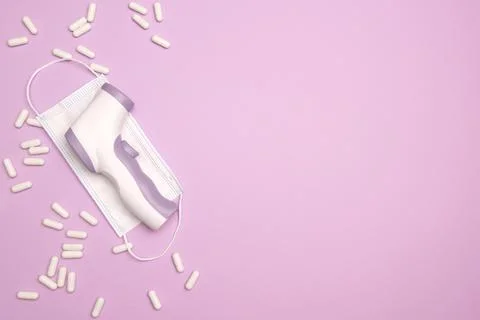 Non-contact infrared thermometer gun isolated on pastel colorful background.  Stock Photos