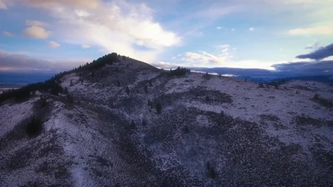 Non-Descript Mountain Top Aerial Winter Landscape With Snow Falling Flyover Peak Stock Footage 87195221