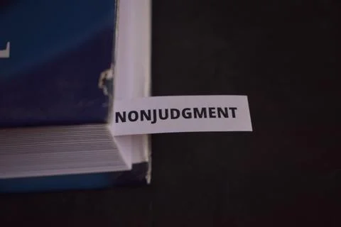 Non Judgment Concept Bookmark Inserted in Book Representing Acceptance, Awa.. Fotos Stock
