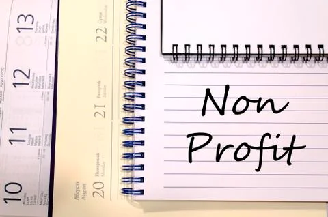 Non profit write on notebook Stock Photos