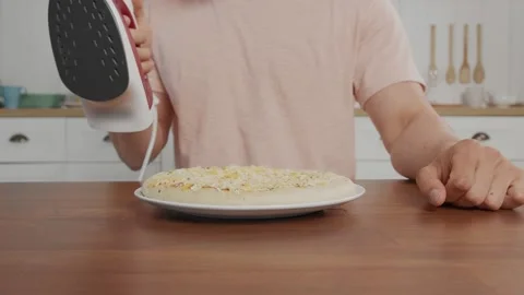 Non-standart frame of the pizza on the table which is steamed with an iron Stock Footage 151678608