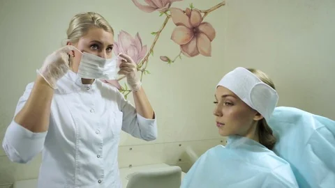 Non-surgical correction of shape of a nose. A young girl during a procedure. HD Stock-Footage 71062491