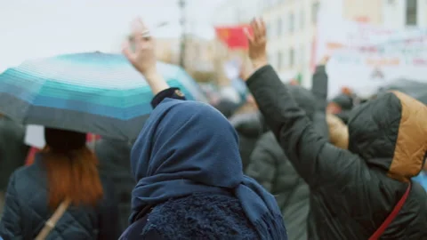 Non violent demonstration crowd waves hands on city square. Harmless activism. Stock Footage 154383296