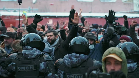 Non-violent protesters showing unarmed hands to riot police line, peaceful rally Stock Footage 171613066