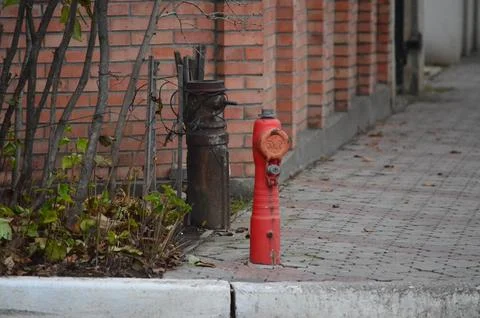 Non-working old fire hydrant down the street. Stock Photos